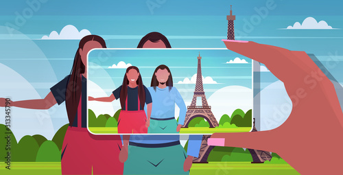 blogger using smartphone camera photographing african american travelers couple on mobile phone blogging shooting vlog concept paris abstract city silhouette background portrait horizontal vector