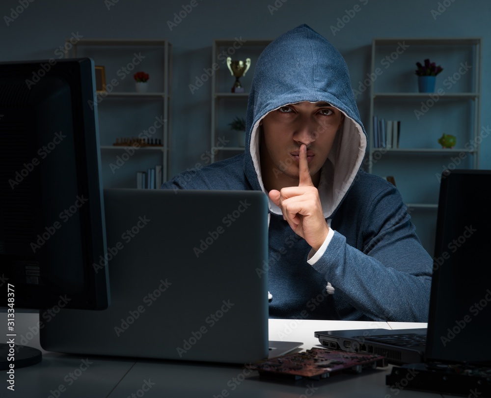 Hacker hacking computer at night Hacker hacking computer at night