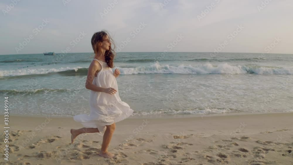 Pretty Girl Running Along Beach in Slow Motion and Seascape Background Pretty Girl Running Along Beach in Slow Motion and Seascape Background