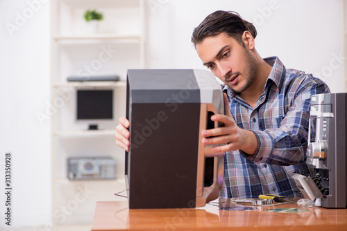 Young engineer repairing musical hi-fi system