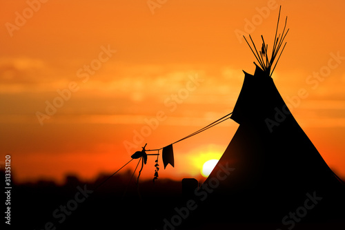 An American Indian tipi (teepee) against an evening sunset. photo