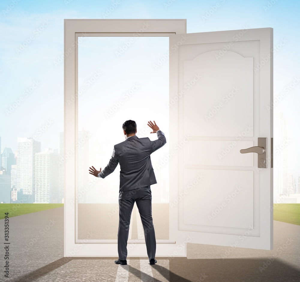 Businessman in front of door in business opportunities concept Businessman in front of door in business opportunities concept