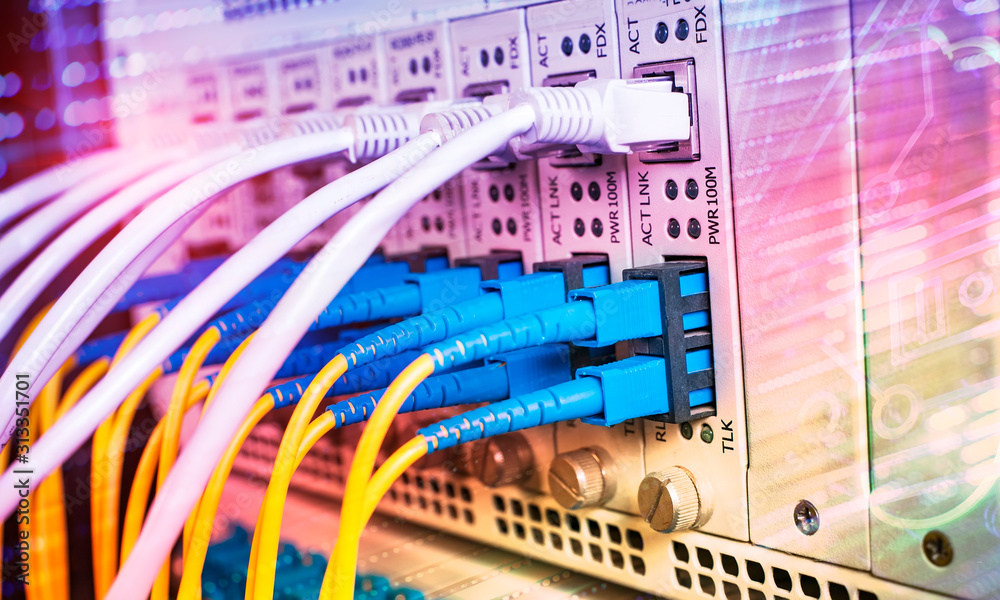 Fiber Optic cables connected to an optic ports and Network cables ...