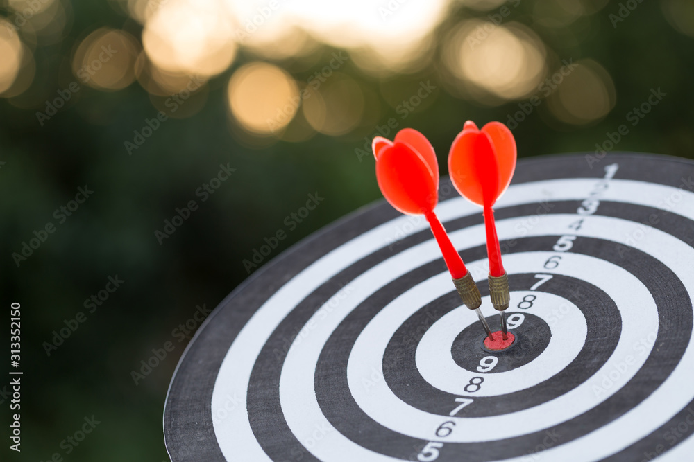 Red dart target arrow hitting on bullseye with,Target marketing and business success concept Red dart target arrow hitting on bullseye with,Target marketing and business success concept