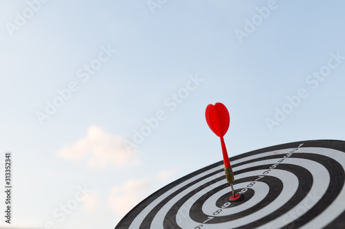 Red dart target arrow hitting on bullseye with,Target marketing and business success concept