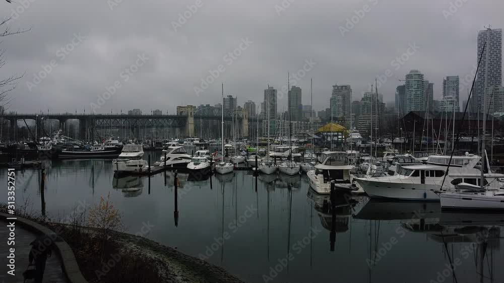 Marina with yachts on Granville Island with the Burard bridge on the background Marina with yachts on Granville Island with the Burard bridge on the background