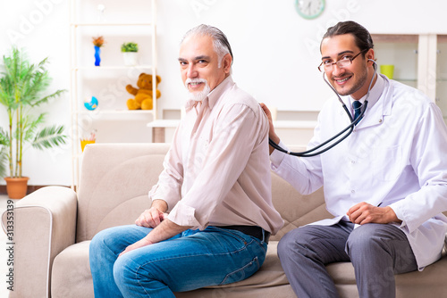 Young male doctor visiting old patient at home © Elnur