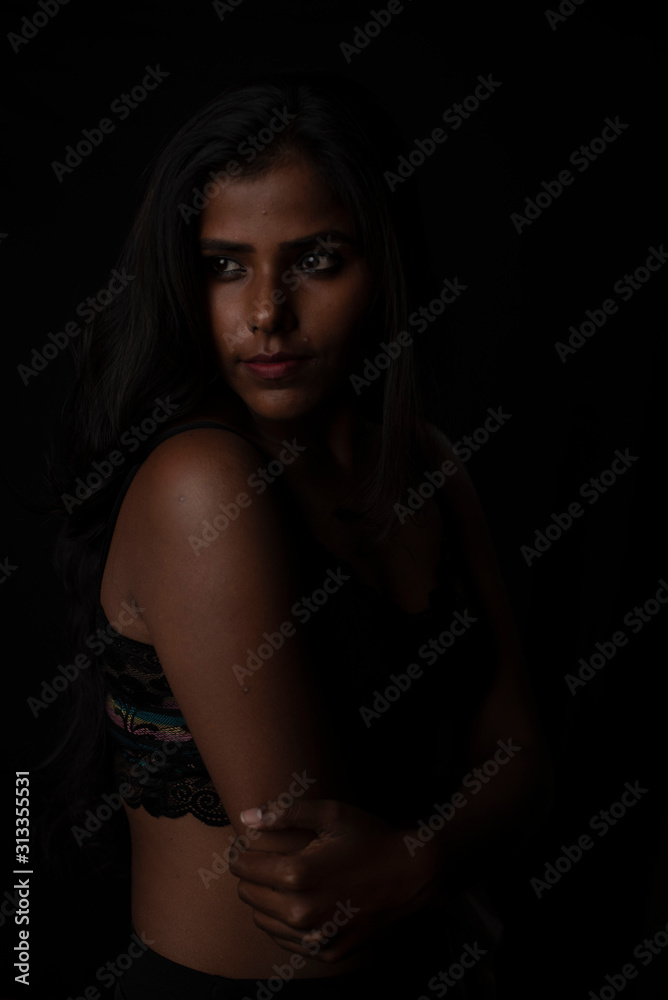 Fashion portrait of an Indian brunette Bengali dark skinned woman with black lingerie standing in black studio copy space background. Indian fashion photography and lifestyle. Fashion portrait of an Indian brunette Bengali dark skinned woman with black lingerie standing in black studio copy space background. Indian fashion photography and lifestyle.