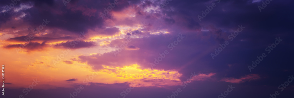 Beautiful sunset sky above clouds with dramatic light. Panorama banner format