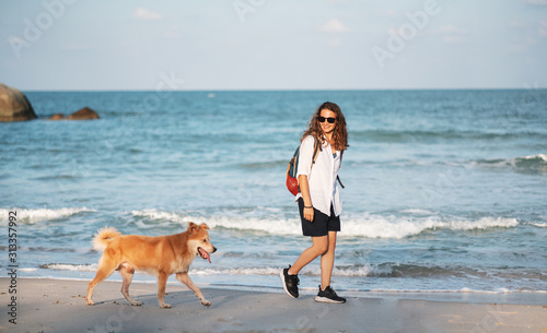 Beautiful Happy Woman Running With Her Dog. Girl Enjoying Summer Holidays Vacations, Having Fun With Her Pet. Summertime Concept.