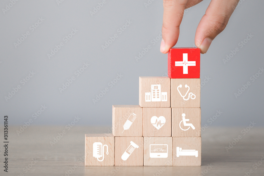 Health Insurance Concept,hand arranging wood block stacking with icon healthcare medical. Health Insurance Concept,hand arranging wood block stacking with icon healthcare medical.