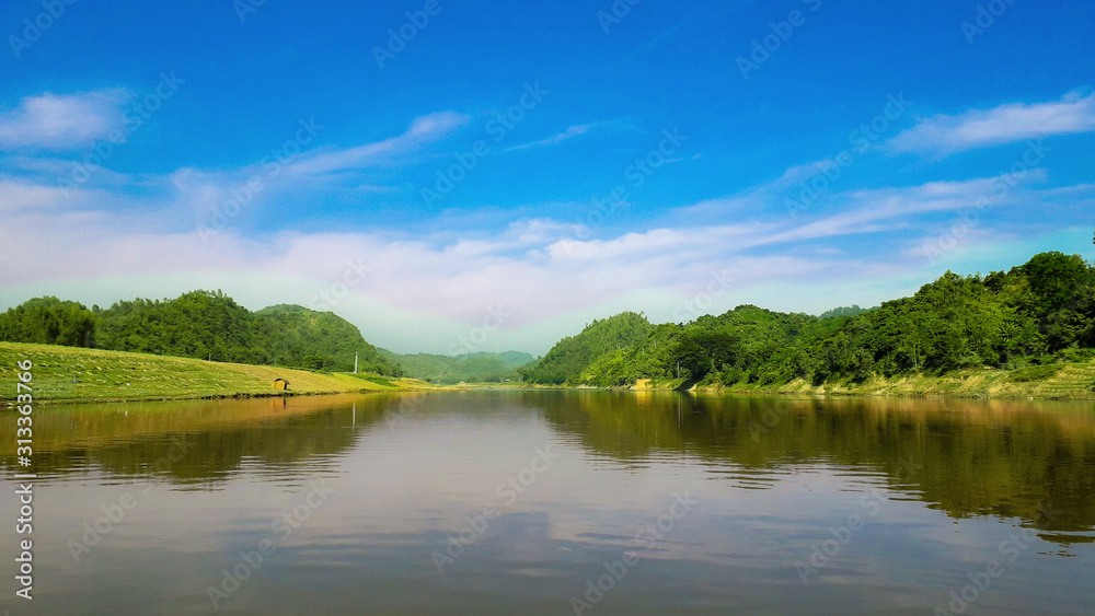 Beautiful Natural Scenery Of River With Blue Sky And Mountain In Background Beautiful Natural Scenery Of River With Blue Sky And Mountain In Background