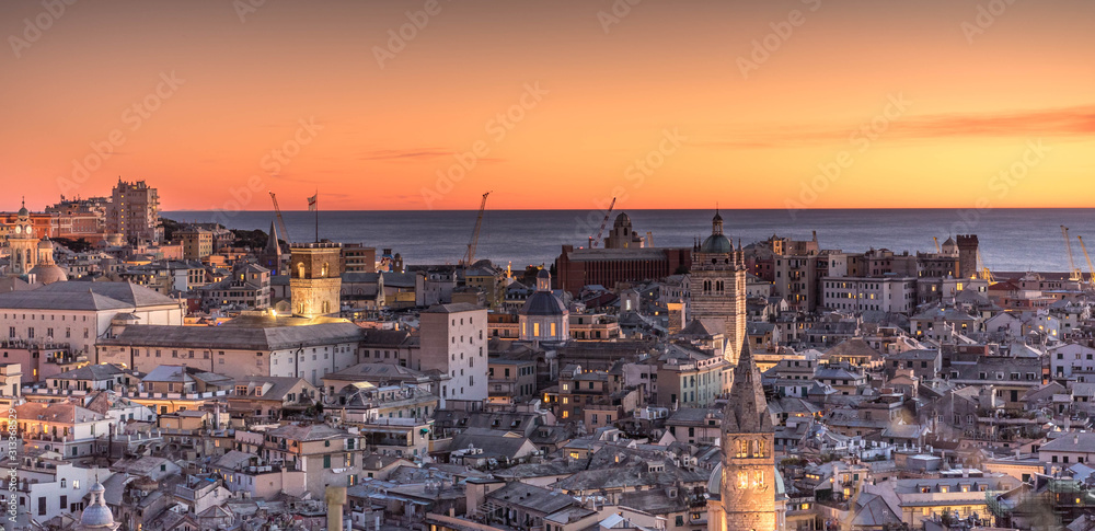 Genova, Italy: Beautiful sunset aerial panoramic view of Genoa historic centre old town (San Lorenzo Cathedral, duomo, Palazzo Ducale), sea and port at dusk. Romantic cityscape Europe at night