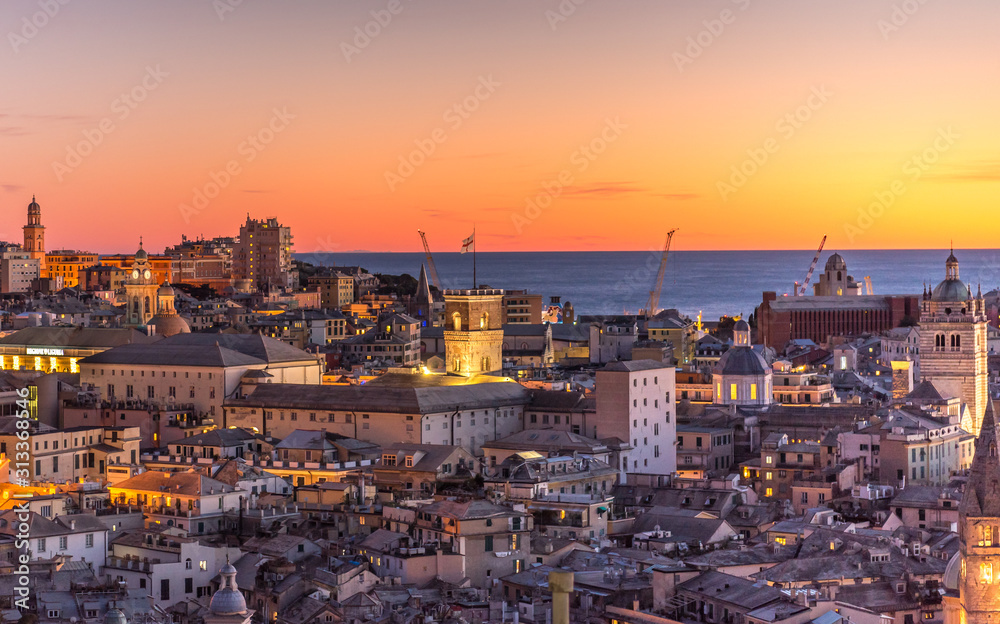 Genova, Italy: Beautiful sunset aerial panoramic view of Genoa historic centre old town (San Lorenzo Cathedral, duomo, Palazzo Ducale), sea and port at dusk. Romantic cityscape Europe at night