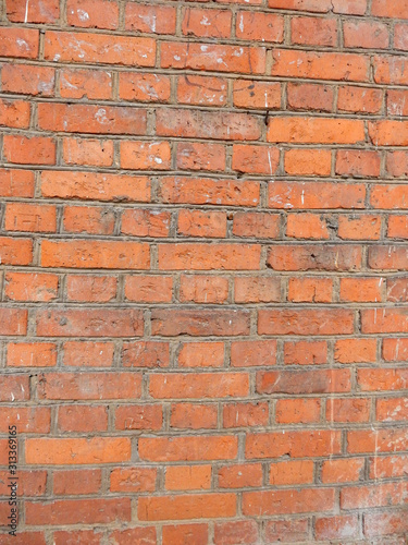 old red brick wall with traces of white paint