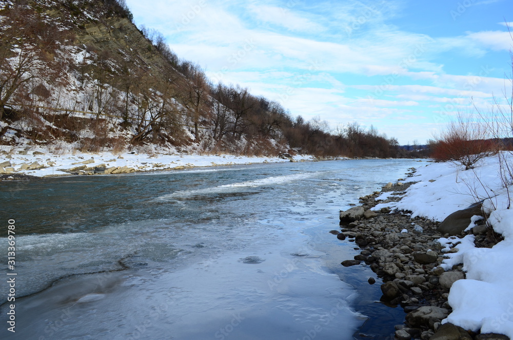winter landscape in the forest with snow and blue sky and river winter landscape in the forest with snow and blue sky and river