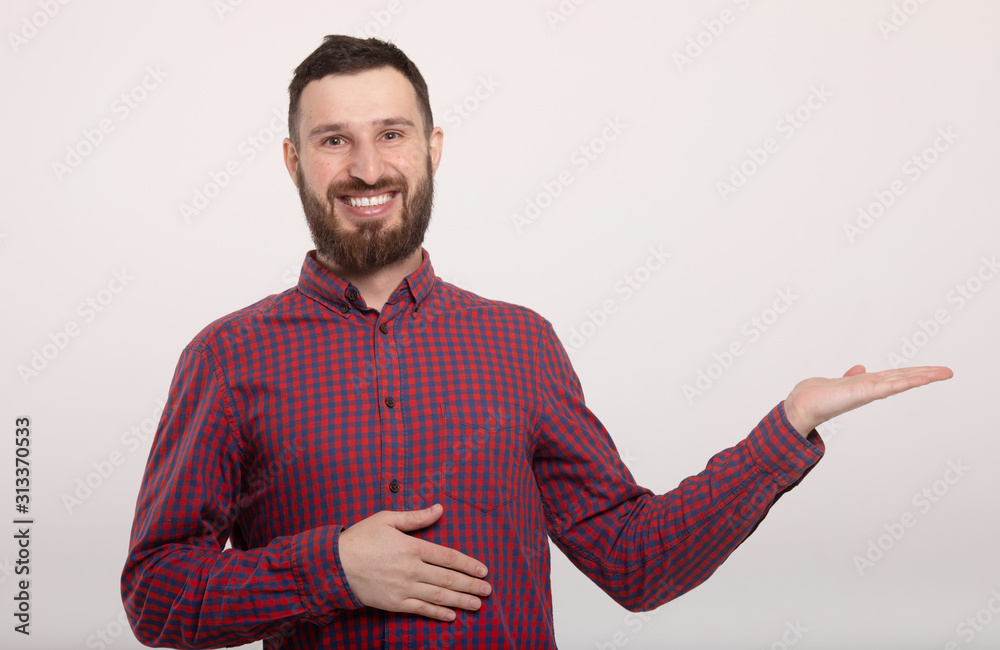 Laughing bearded man pointing to the side. Isolated on white background. Laughing bearded man pointing to the side. Isolated on white background.