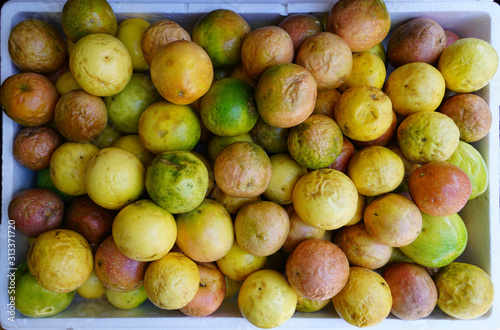 Crate of colorful ripe passion fruits at a food market