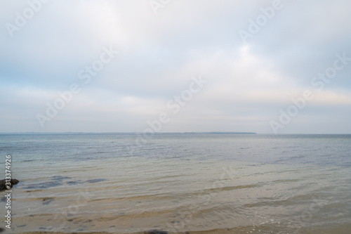 Wonderful view of a beach with many stones on and in the water