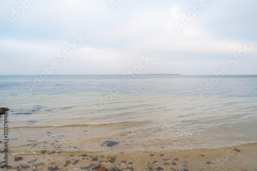 Wonderful view of a beach  with many stones on and in the water