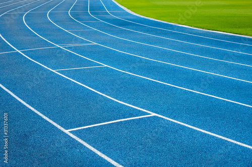 Fototapeta Naklejka Na Ścianę i Meble -  Blue running treadmill track with lane numbers in stadium outdoors.Starting grid of race track at the stadium