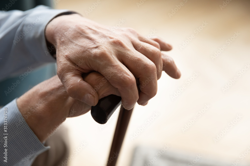 Close up view 60s lovely male hands holding cane