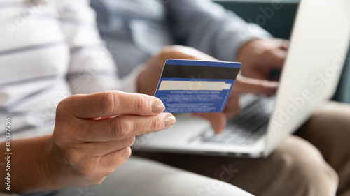 Cuadro en lienzo Female holding credit card making online payment, closeup view