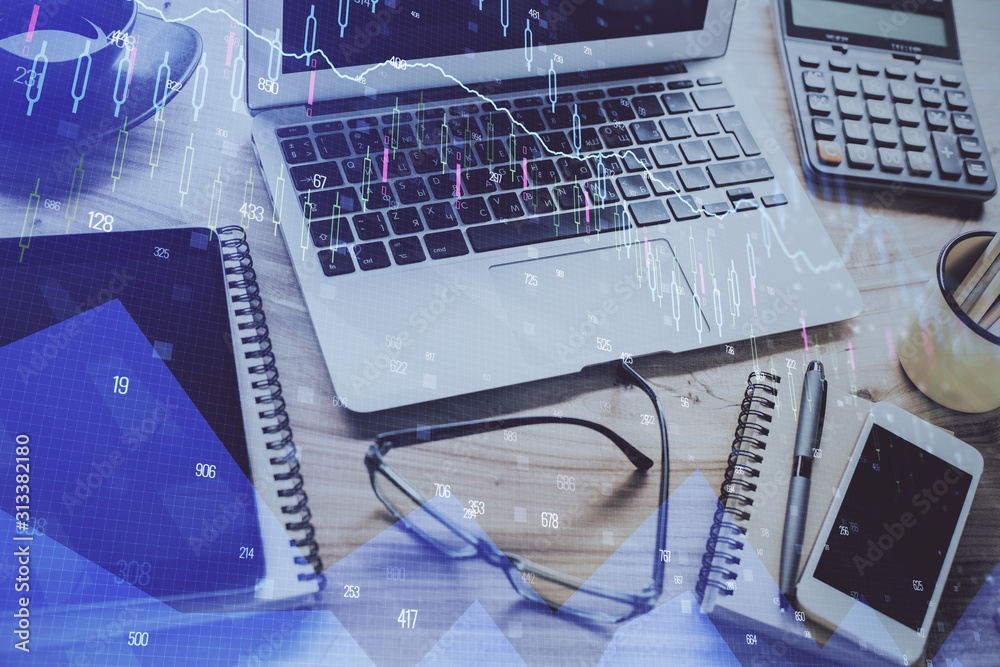 Financial graph colorful drawing and table with computer on background. Double exposure. Concept of international markets. Financial graph colorful drawing and table with computer on background. Double exposure. Concept of international markets.