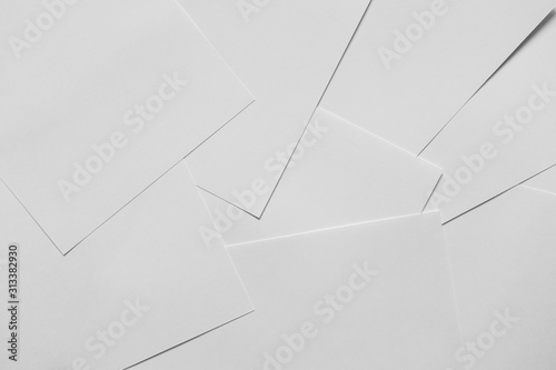 Heap of scattered white empty clean blank paper sheets. Top view, horizontal. Template for posters. Mockup placards
