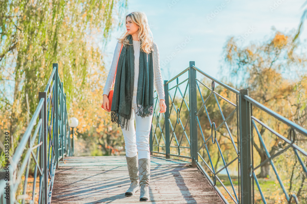 Spring walk, woman in fashionable casual look at park, modern ladies lifestyle Spring walk, woman in fashionable casual look at park, modern ladies lifestyle
