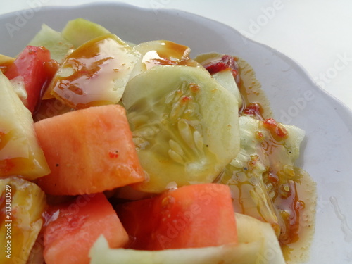 lotis buah or rujak (sweat, sour, spicy and fresh). fruit with hot chili paste. indonesian traditional fruit salad photo