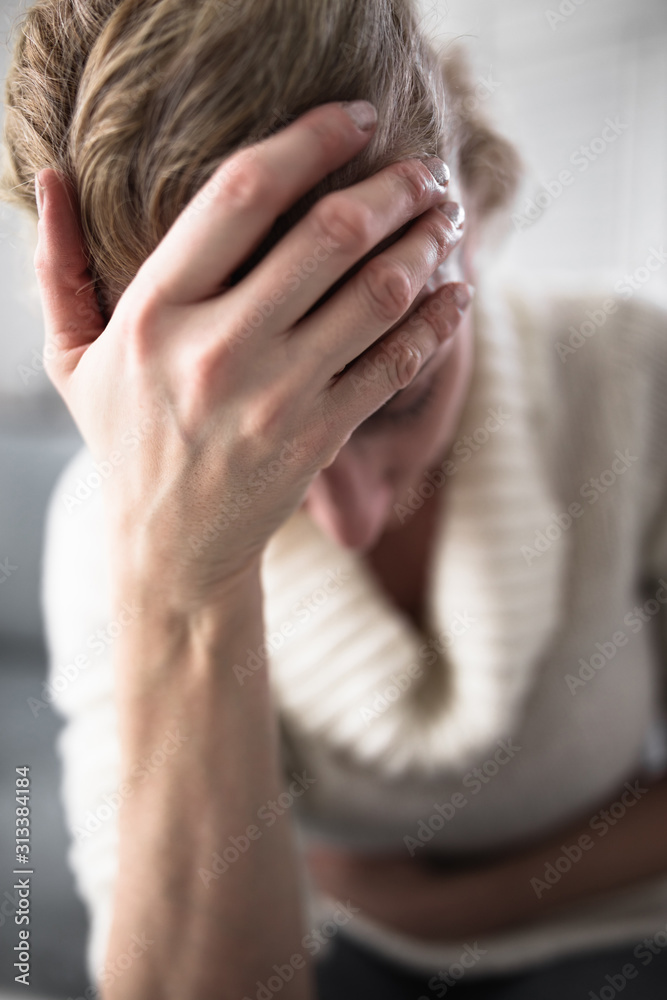 Fototapeta premium Pregnant tired exhausted woman with stomach and head issues at h