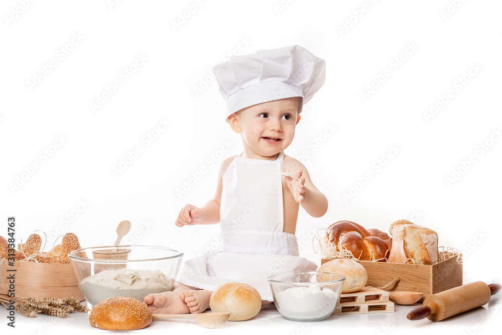 child with bread on bakery-like background wearing cook-hat child with bread on bakery-like background wearing cook-hat
