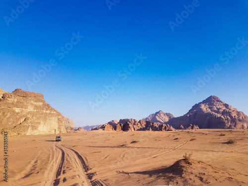 Sunset safari at the Wadi Rum desert  Jordan. Pick up truck tour with bedouins. Car rides on the sand in the middle of two rocky mountains at the famous desert. 