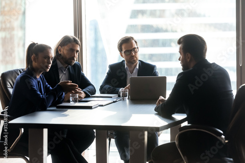 Male candidate speak at job interview in office