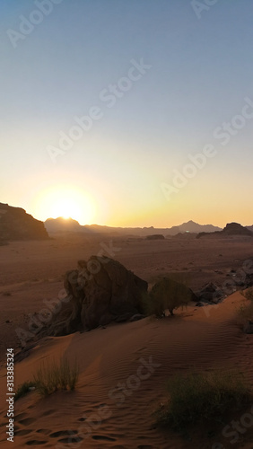 Sunset in Wadi Rum desert. Sundown and rocky mountains. Safari ride on pick up trucks. Surface of Mars.