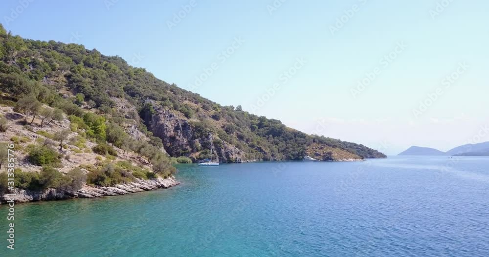Aerial view of sailing boat anchoring in a lonely bay with blue green waters Aerial view of sailing boat anchoring in a lonely bay with blue green waters