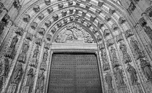 SEVILLE, SPAIN - OCTOBER 28, 2014: The main west portal (Puerta de la Asuncion) of Cathedral de Santa Maria de la Sede by Pedro de Toledo, J. de Hoces, F.de Rosales for neo-gothic part. photo