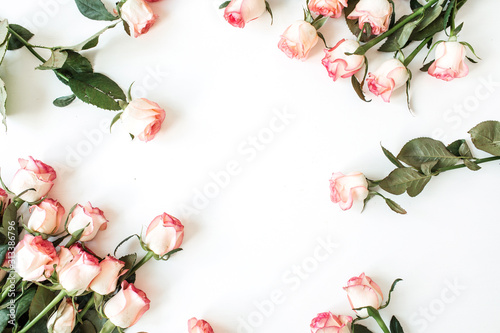 Frame with blank copy space mockup made of pink rose flowers on white background. Flat lay, top view floral concept.