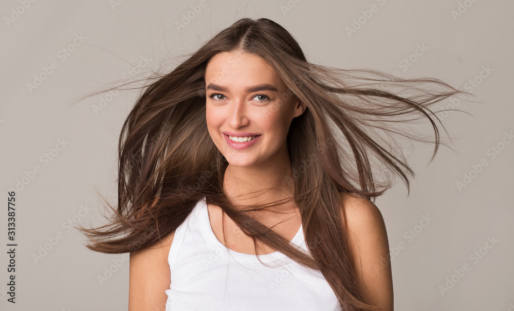 Happy woman with flying hair smiling to camera Happy woman with flying hair smiling to camera
