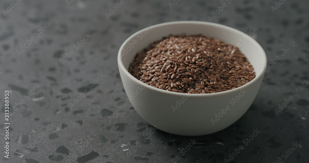 flaxseed in white bowl on terrazzo countertop with copy space flaxseed in white bowl on terrazzo countertop with copy space