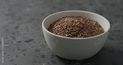 Wallpaper Mural flaxseed in white bowl on terrazzo countertop with copy space Torontodigital.ca