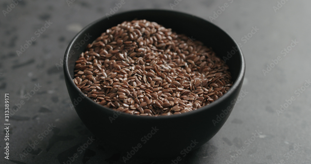 flaxseed in black bowl on terrazzo countertop with copy space flaxseed in black bowl on terrazzo countertop with copy space