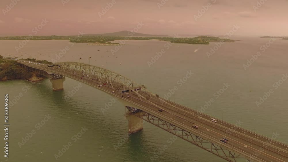 Aerial: Auckland harbour bridge & orange sky from the Australian bush fires that swept accross the Tasman Sea. Auckland, New Zealand. 5 January 2019 Aerial: Auckland harbour bridge & orange sky from the Australian bush fires that swept accross the Tasman Sea. Auckland, New Zealand. 5 January 2019