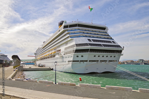 Rear view of big modern Costa Cruises cruise ship liner docked at cruise terminal on windy day in Malaga, Spain during Mediterranean cruising photo