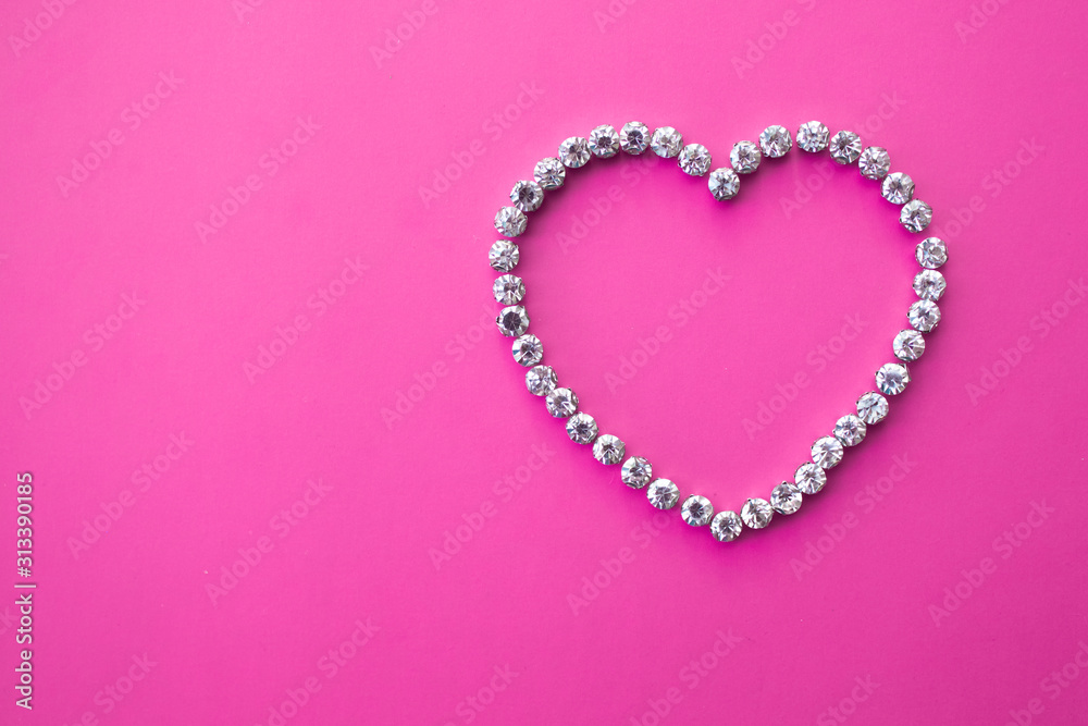 heart made of rhinestones on a pink background with text space. valentine's day layout