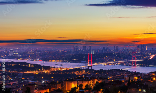 Sunset and illumination of the Bosphorus bridge and buildings of Istanbul, Turkey