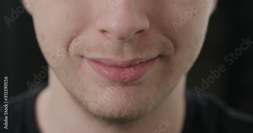 closeup shot of man mouth smiling