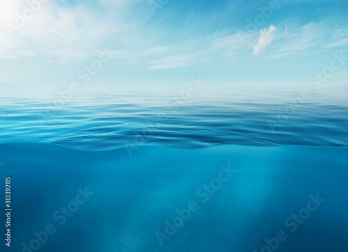 Fototapeta Naklejka Na Ścianę i Meble -  Blue sea or ocean water surface and underwater with sunny and cloudy sky