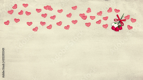 Small textile hearts and flowers on concrete surface with copy space. Romantic vintage widescreen background © JAYANNPO